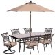 Hanover 7-pc Outdoor Dining Set with Rectangular Glass Table, 2 Swivels, Umbrella and Base with Natural Oat Cushions